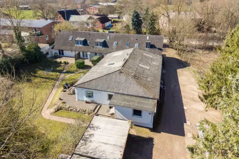 Luftaufnahme eines Mehrfamilienhauses, das in Braak (Bosau) zum Verkauf steht.